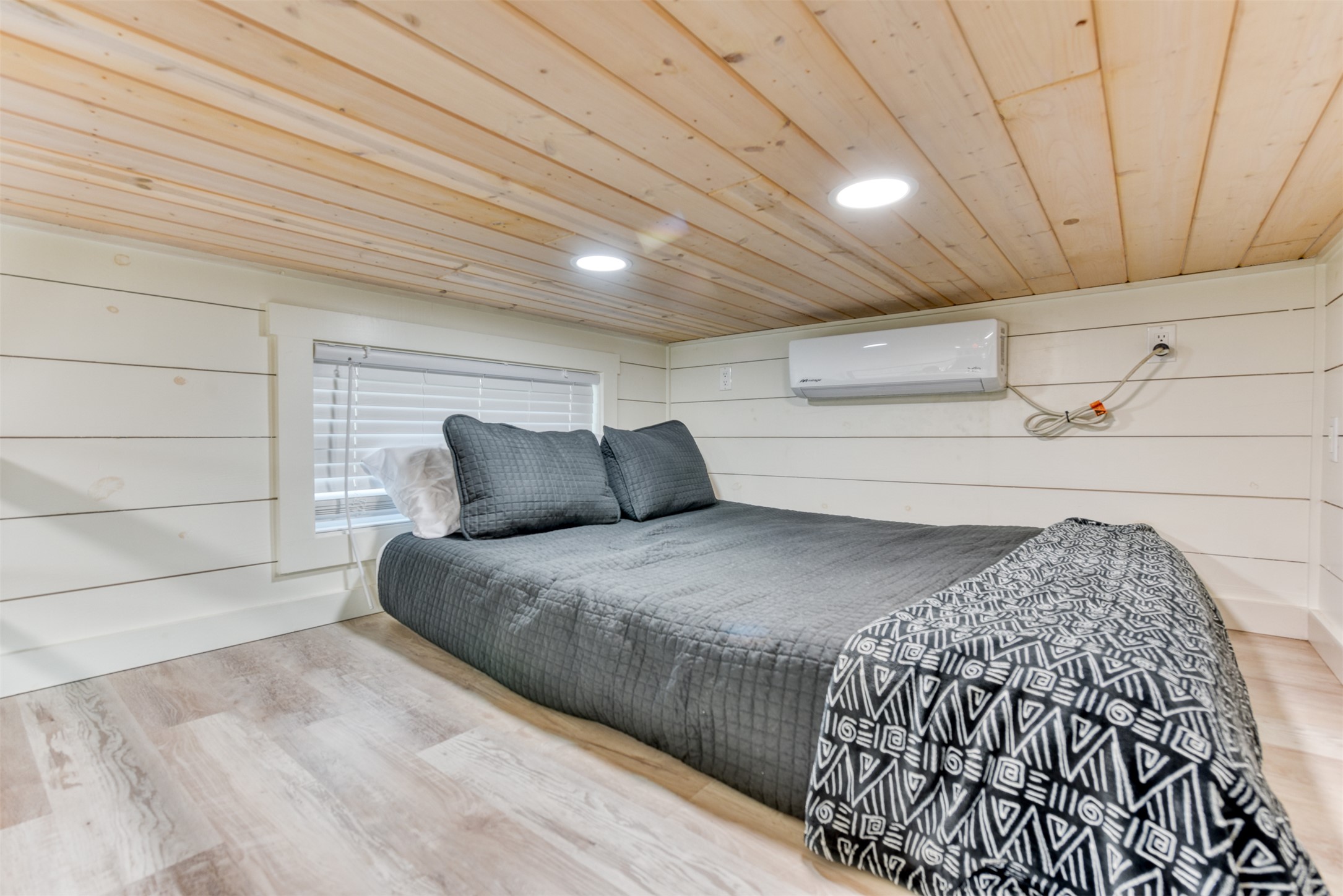 1156 Narrows Road Blanco, TX 78606 - Photo 37 of 40 Compact sleeping area featuring wood-finish ceiling panels, recessed lighting, wood-look plank flooring, a window with blinds, and a wall-mounted mini-split system