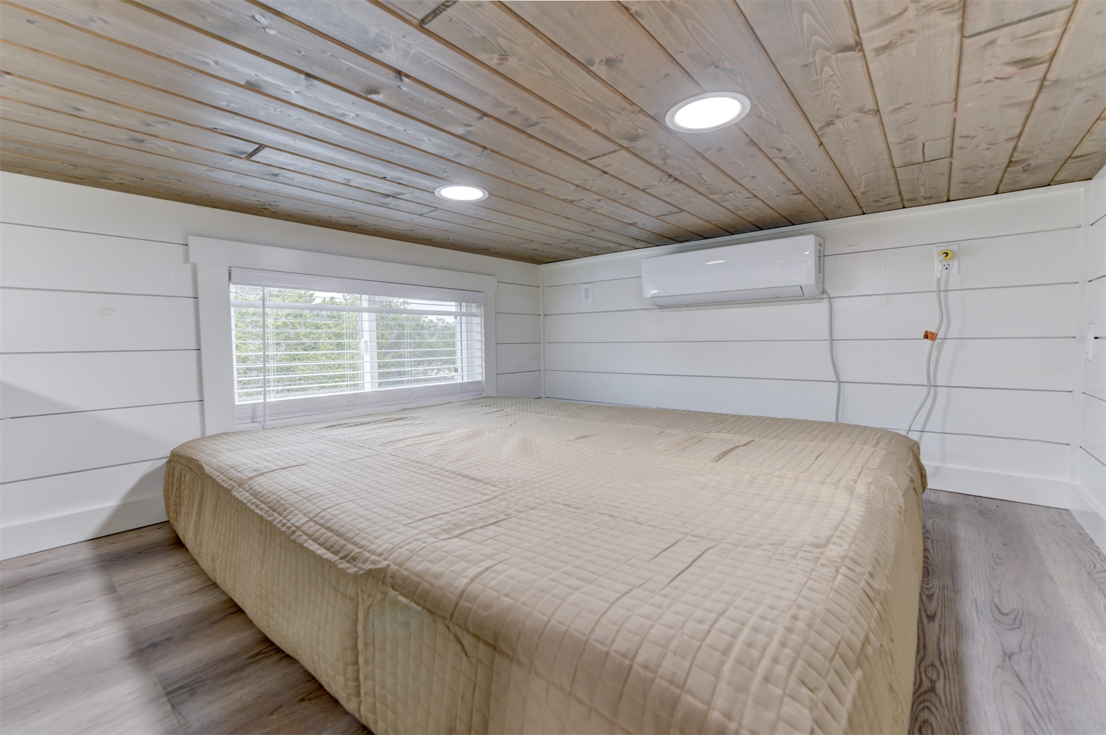 1156 Narrows Road Blanco, TX 78606 - Photo 9 of 40 Loft space featuring wood-finish flooring, white shiplap walls, and a wood-panel ceiling