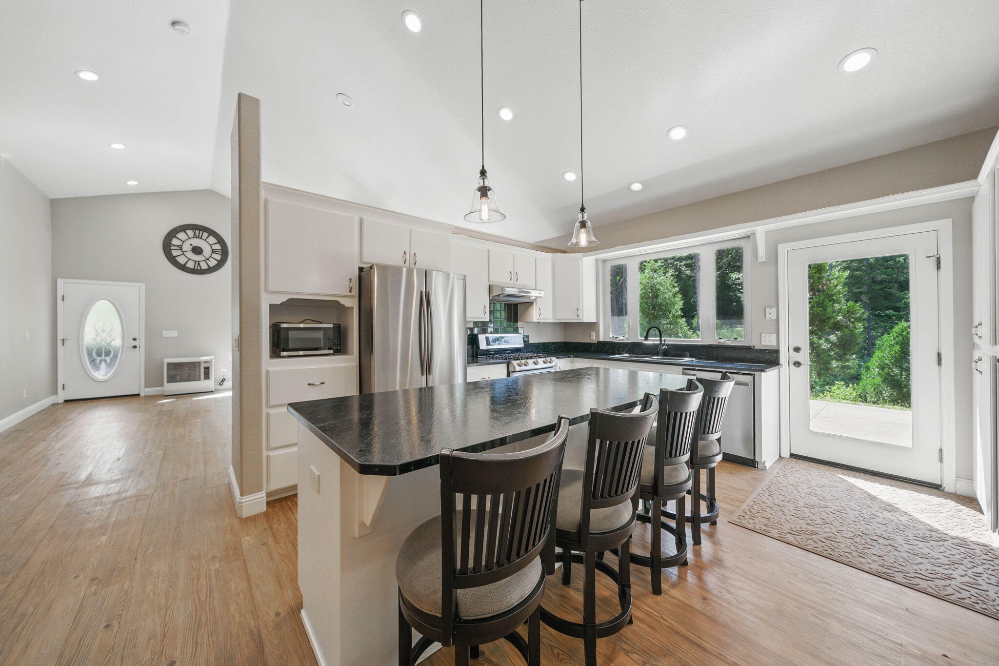 15399 Star Flower Road Oak Run, CA 96069 - Photo 11 of 44 a kitchen with stainless steel appliances a dining table chairs refrigerator and sink