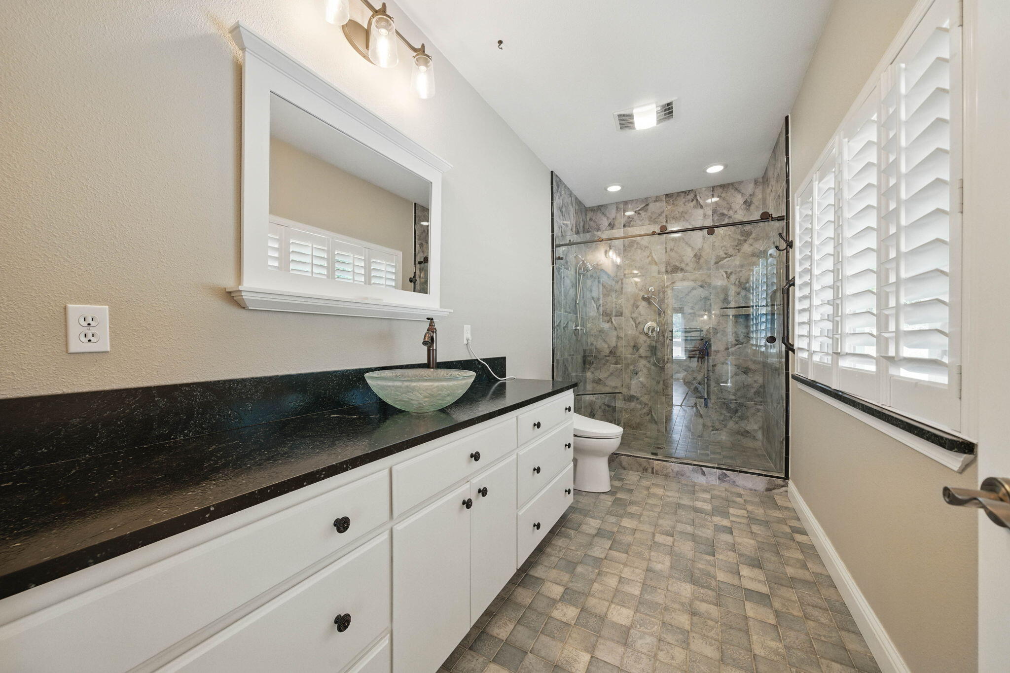15399 Star Flower Road Oak Run, CA 96069 - Photo 17 of 44 a bathroom with a granite countertop sink a toilet a mirror and shower