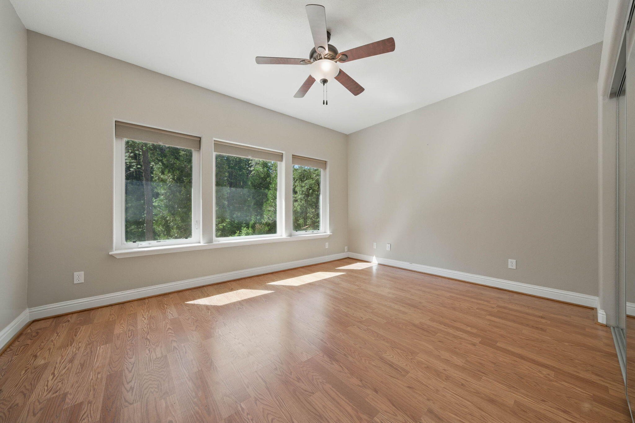 15399 Star Flower Road Oak Run, CA 96069 - Photo 20 of 44 a view of an empty room with wooden floor and a window