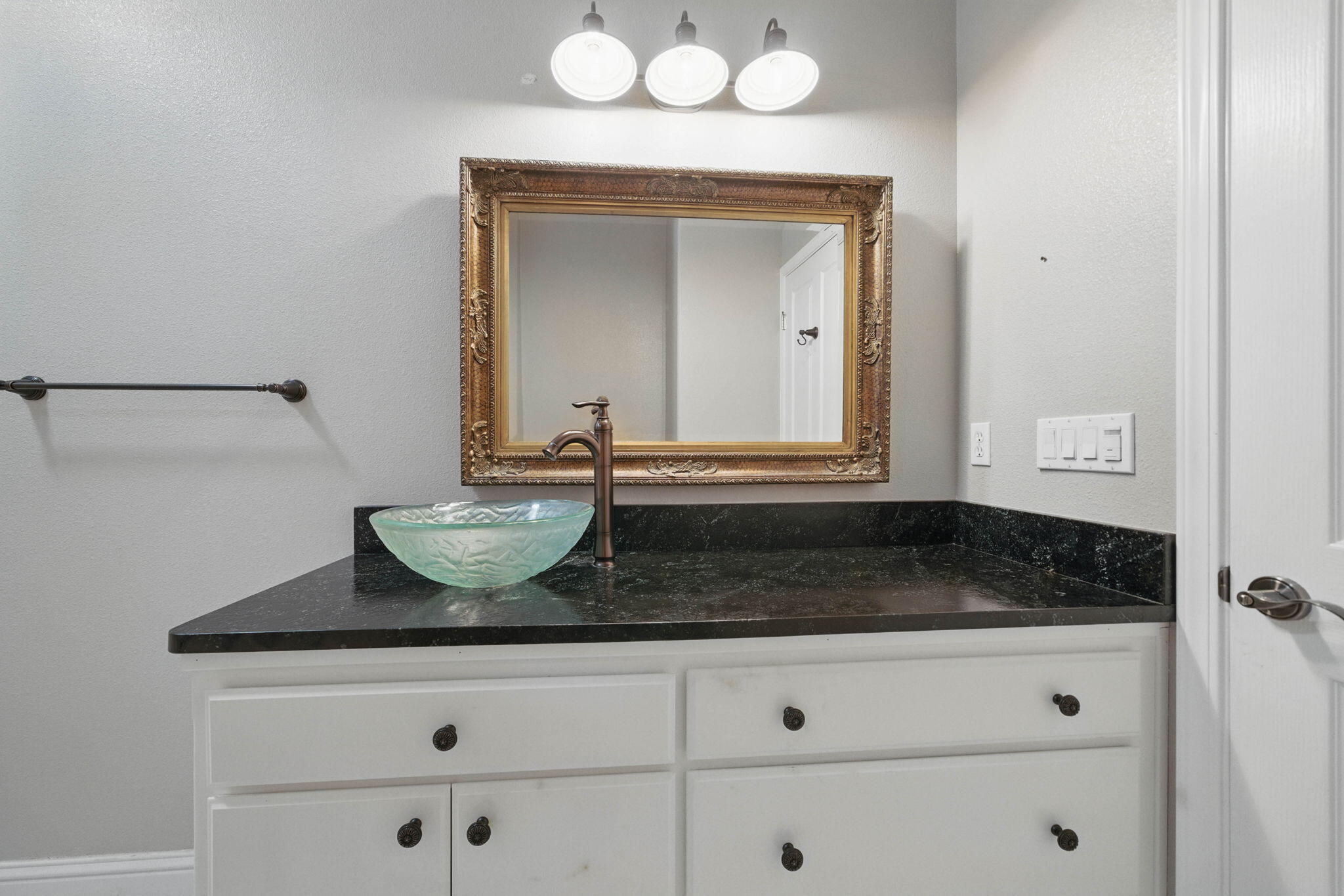 15399 Star Flower Road Oak Run, CA 96069 - Photo 22 of 44 a bathroom with a granite countertop sink and a mirror
