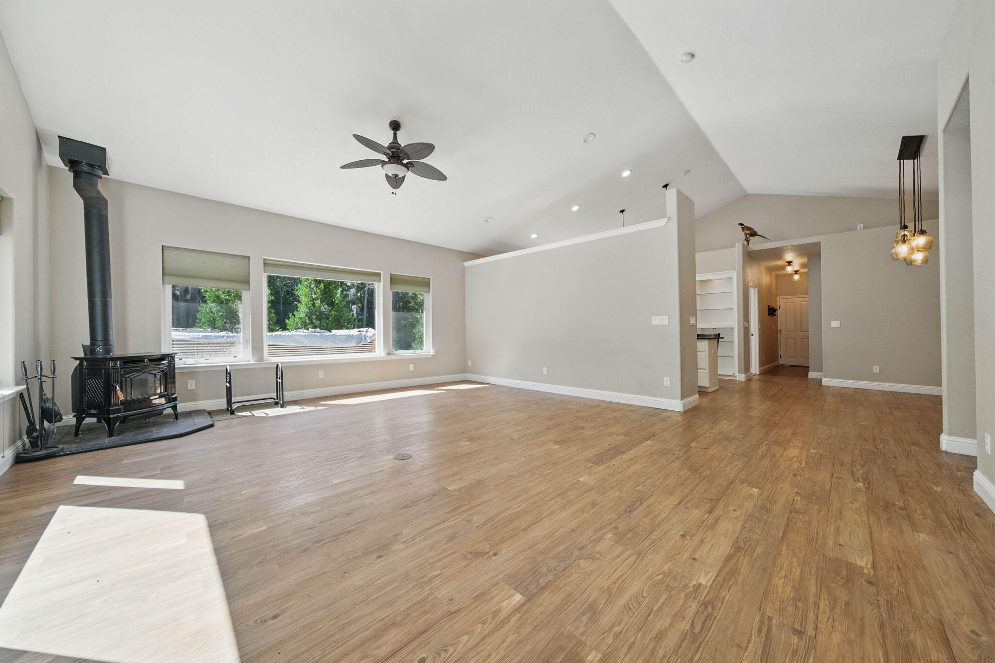 15399 Star Flower Road Oak Run, CA 96069 - Photo 6 of 44 a view of a livingroom with a hardwood floor and a ceiling fan
