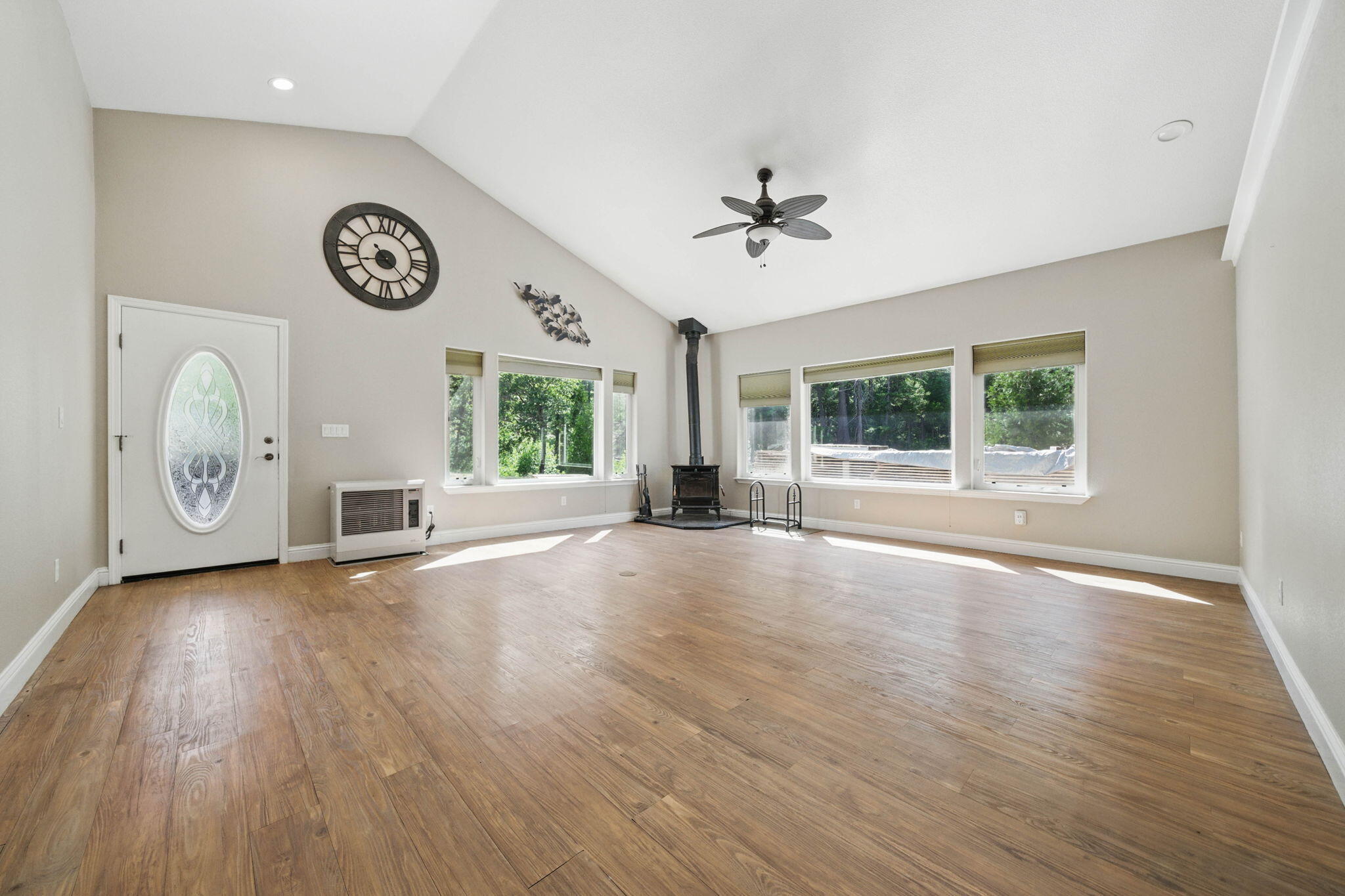 15399 Star Flower Road Oak Run, CA 96069 - Photo 7 of 44 a view of an empty room with a window and wooden floor