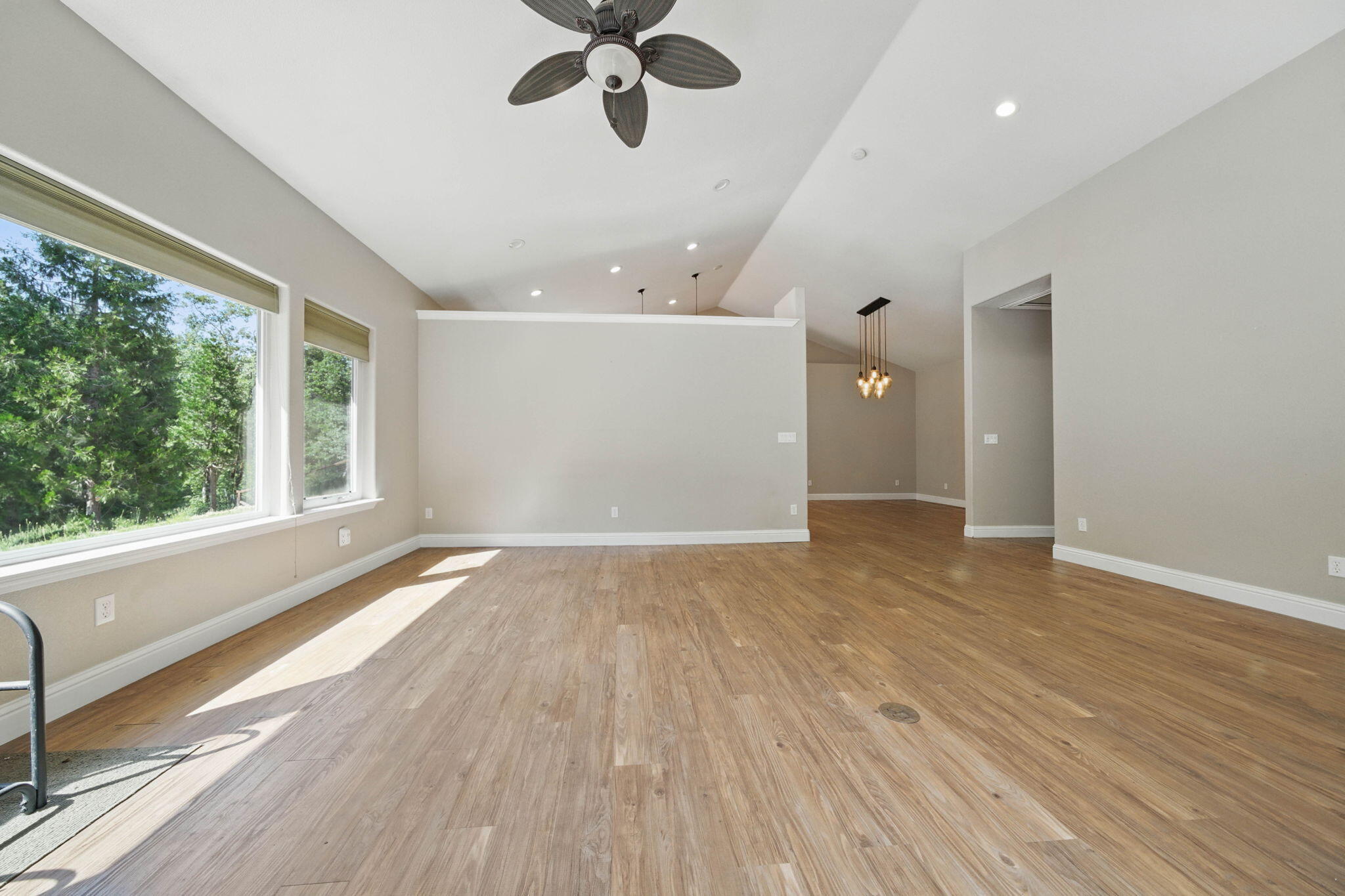 15399 Star Flower Road Oak Run, CA 96069 - Photo 8 of 44 an empty room with wooden floor fan and windows