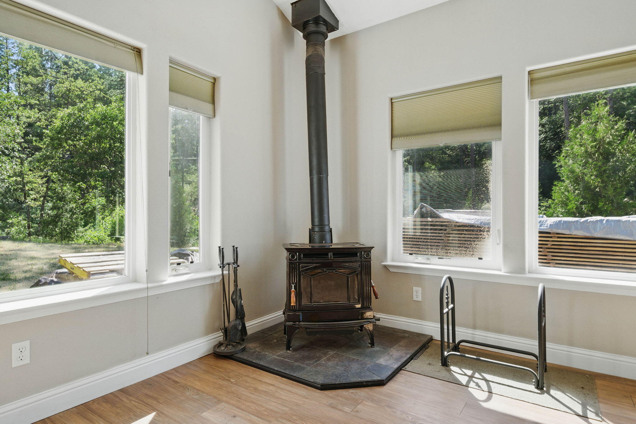 15399 Star Flower Road Oak Run, CA 96069 - Photo 9 of 44 a living room with a fireplace furniture and a large window