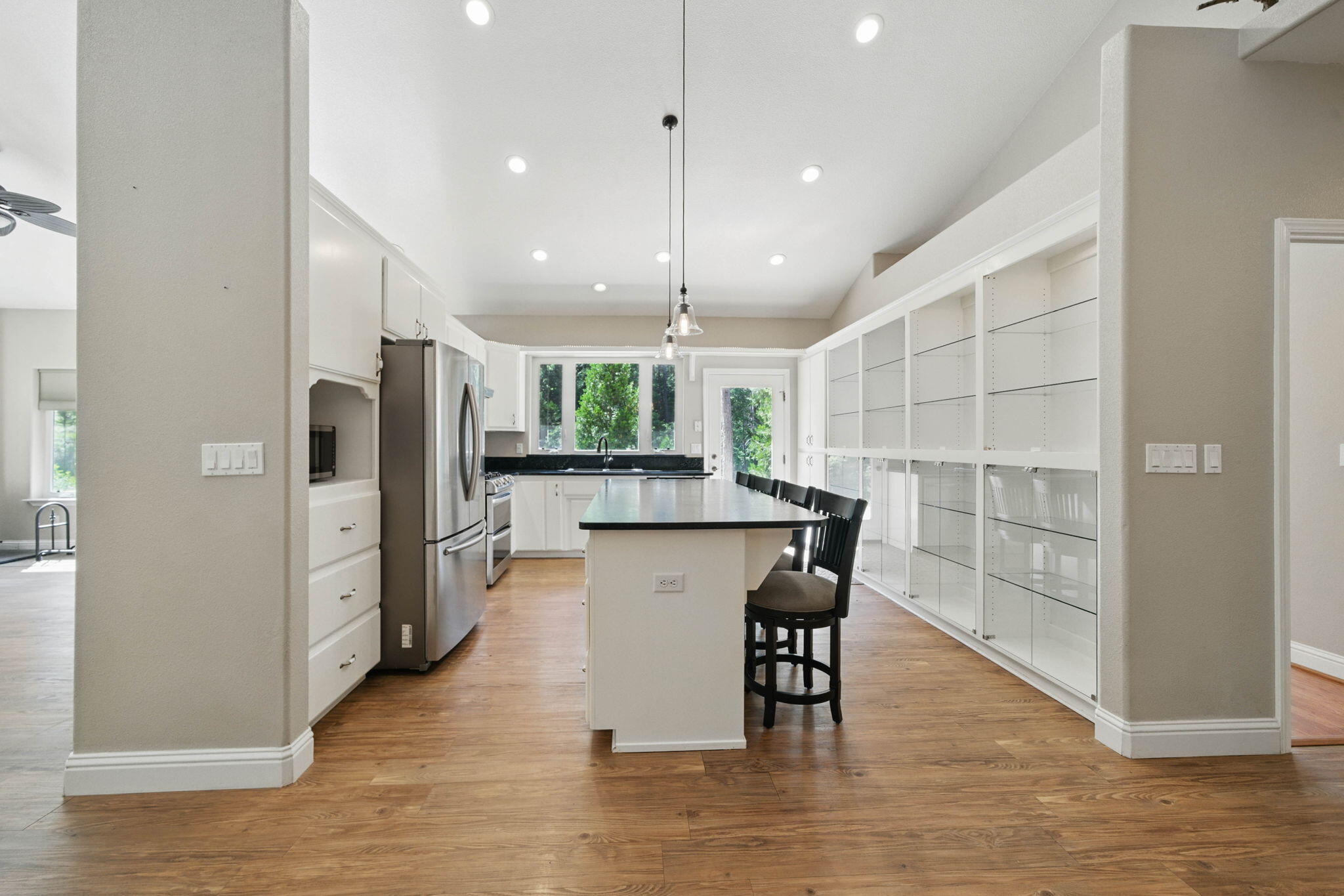 15399 Star Flower Road Oak Run, CA 96069 - Photo 10 of 44 a kitchen with stainless steel appliances granite countertop a refrigerator a sink dishwasher a dining table and chairs with wooden floor