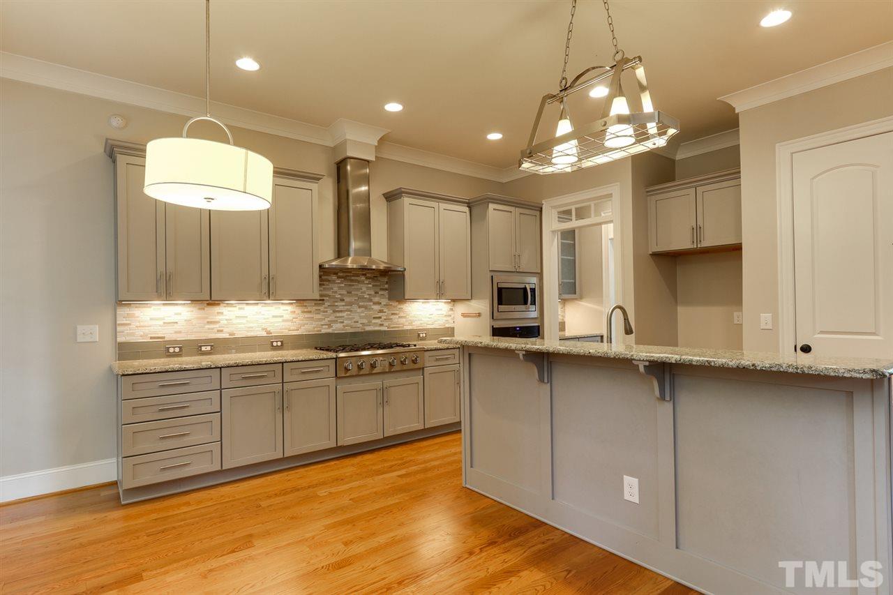 1103 Temple Street Raleigh, NC 27609 - Photo 4 of 30 Main level gourmet kitchen with gas cooktop and hood