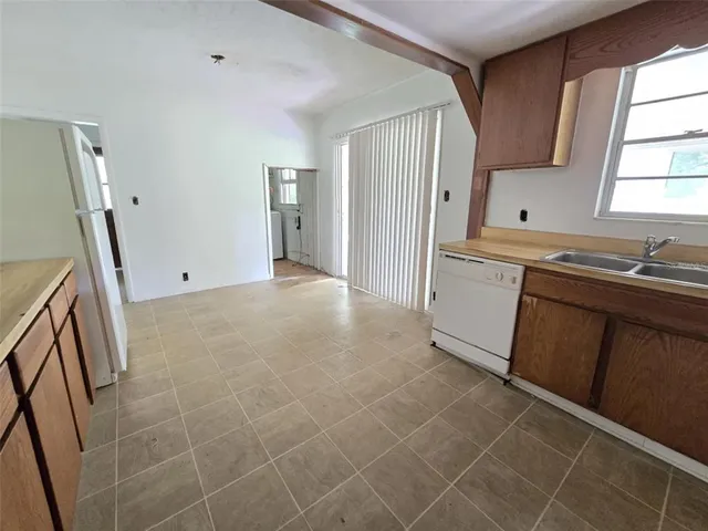 a view of a kitchen with a sink and a window