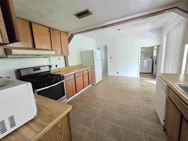a kitchen that has a sink and a stove