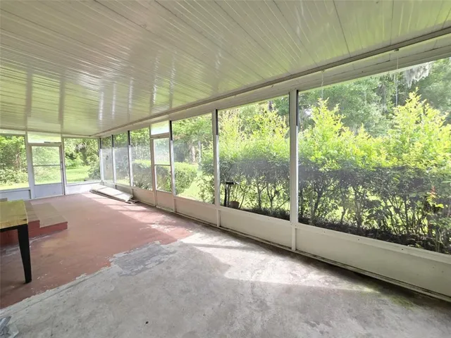 a spacious bedroom with a large bed and large windows