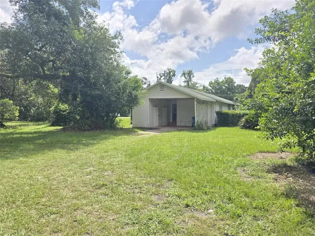 a front view of house with yard and trees
