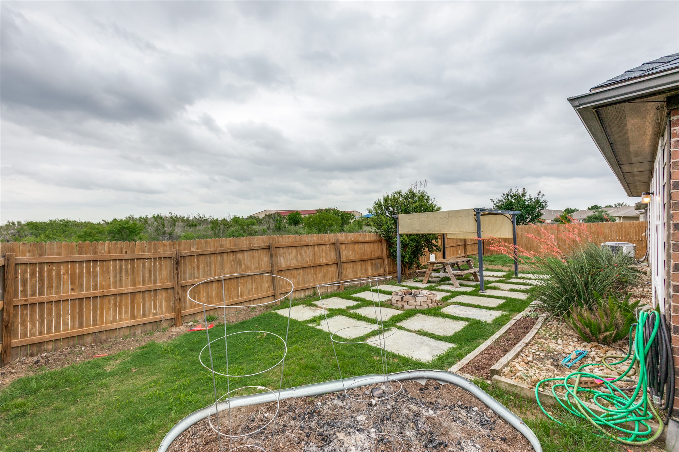 2909 Centrum Drive Austin, TX 78754 - Photo 27 of 30 The property features a fenced yard with a combination of lawn and a paved patio area