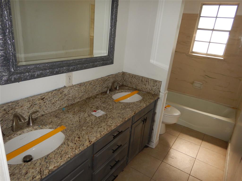 907 Japonica Lane Shreveport, LA 71118 - Photo 13 of 17 a bathroom with a granite countertop sink and a mirror