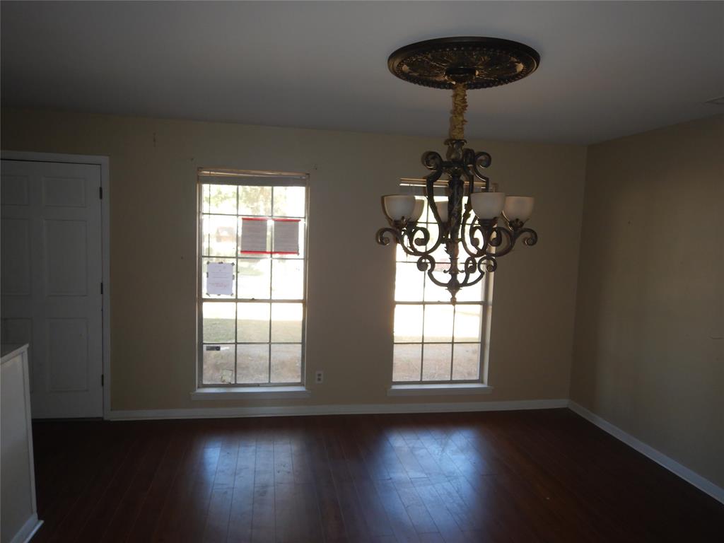 907 Japonica Lane Shreveport, LA 71118 - Photo 5 of 17 a room with wooden floor chandelier and a window