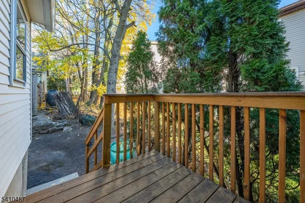 a balcony with wooden floor and outdoor space