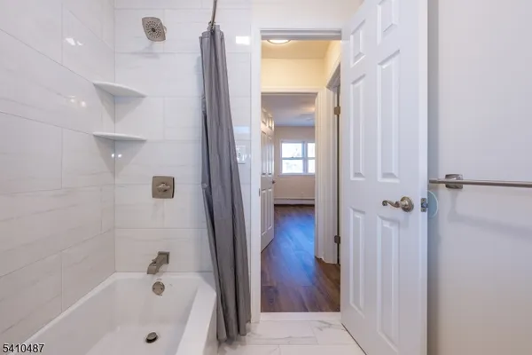 a bathroom with a bathtub and a shower