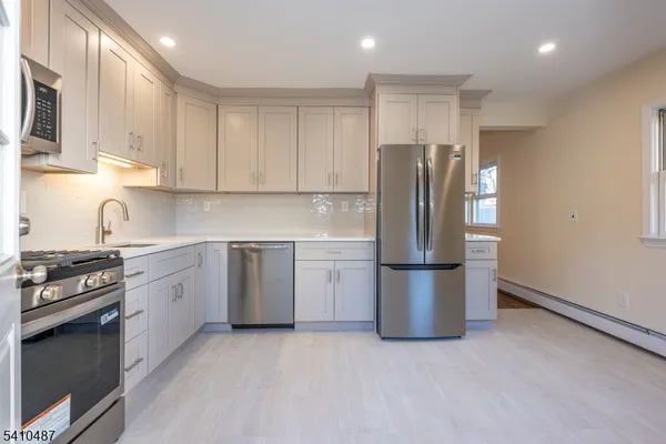 a kitchen with a stove a refrigerator and a sink