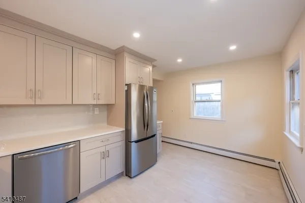 a kitchen with stainless steel appliances a refrigerator sink and cabinets