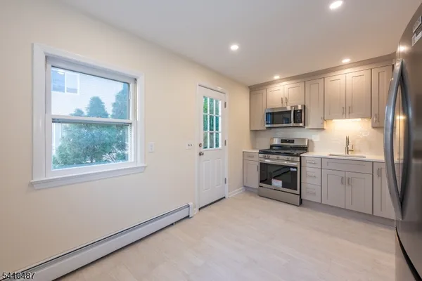 a kitchen with a refrigerator stove and microwave