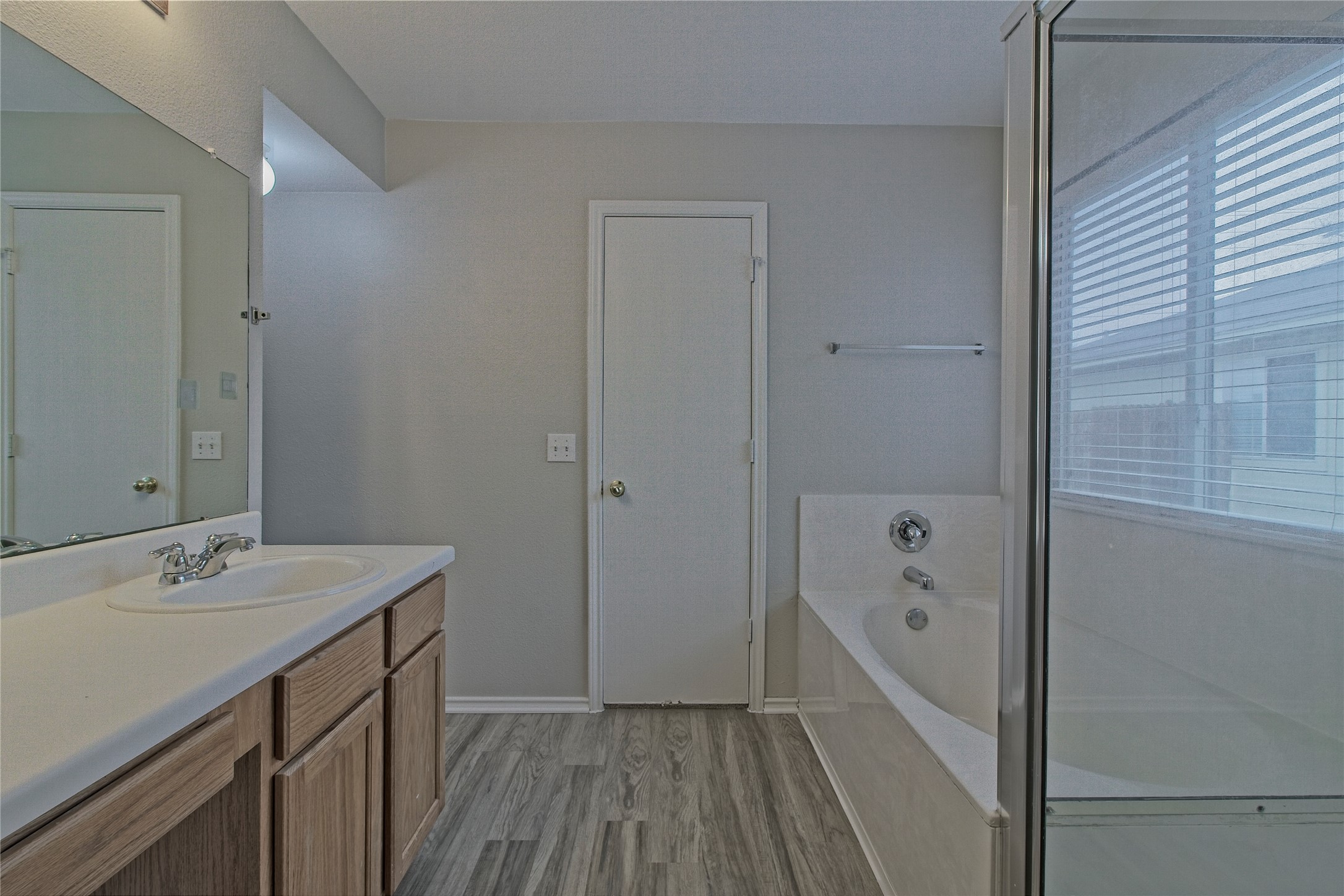 232 Brickyard Lane Jarrell, TX 76537 - Photo 19 of 31 A well-appointed bathroom with a vanity, built-in tub, and walk-in shower.