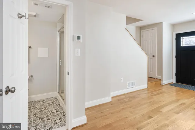 a bathroom with a toilet sink vanity and mirror