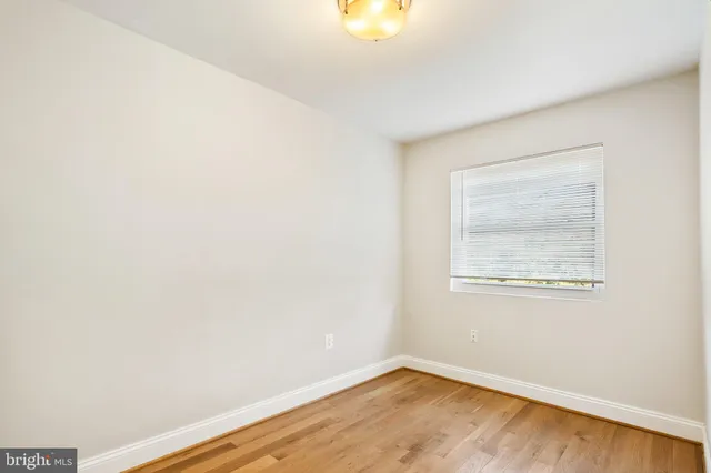 a view of hallway with wooden floor
