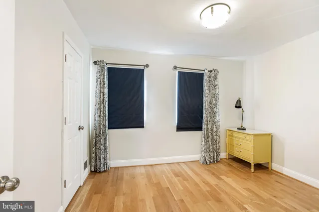 a view of a room with wooden floor