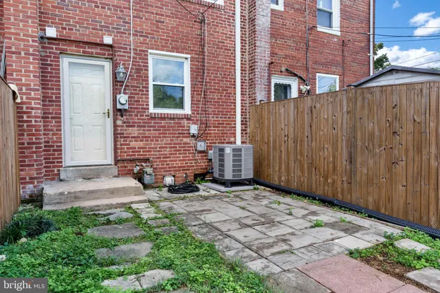 a view of a brick house with a yard