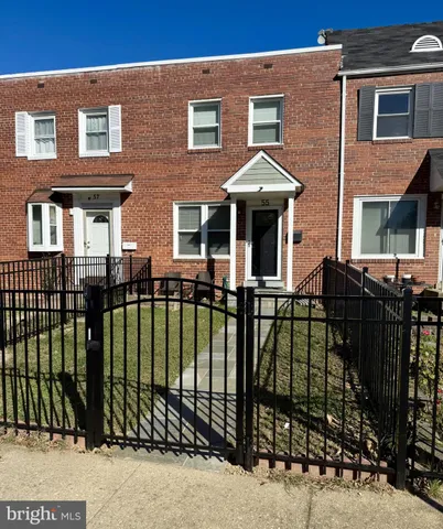 a view of a brick house with large windows