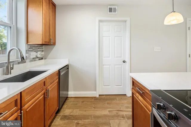 a kitchen that has a sink and a stove