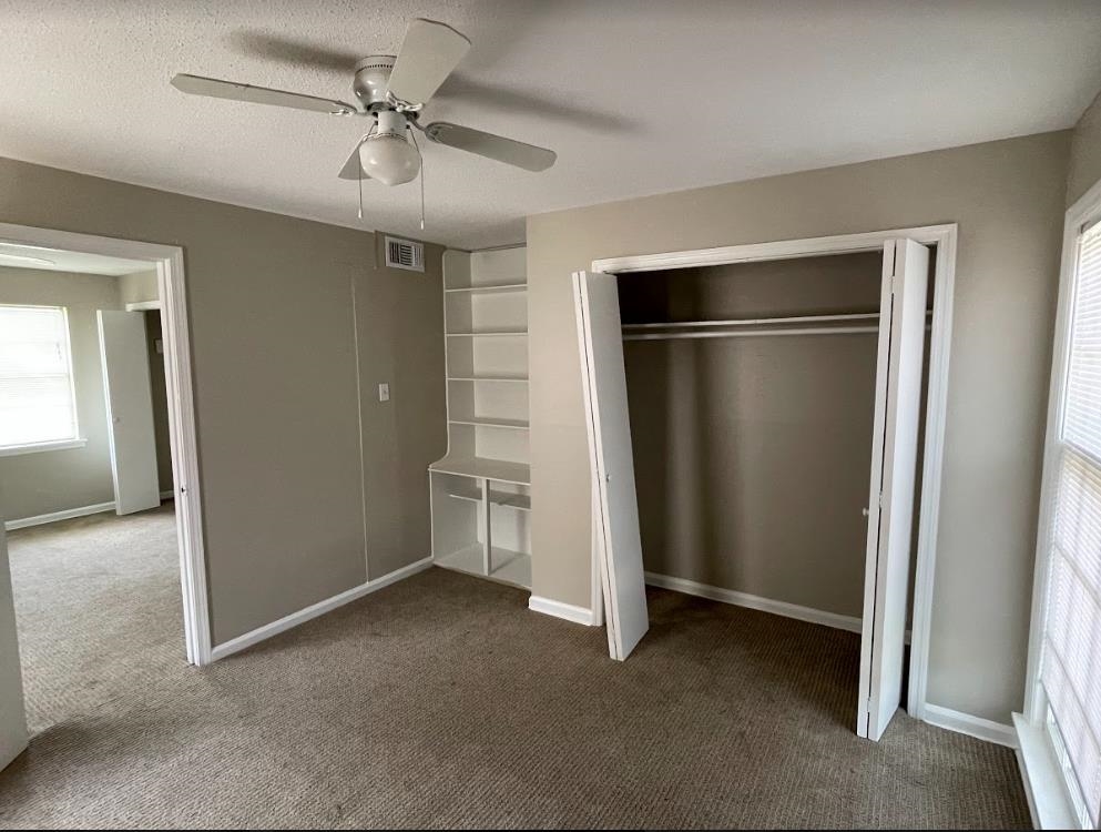 4875 Knight Arnold Road Memphis, TN 38118 - Photo 12 of 16 an empty room with windows and closet