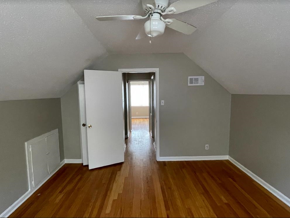 4875 Knight Arnold Road Memphis, TN 38118 - Photo 14 of 16 an empty room with wooden floor closet and windows