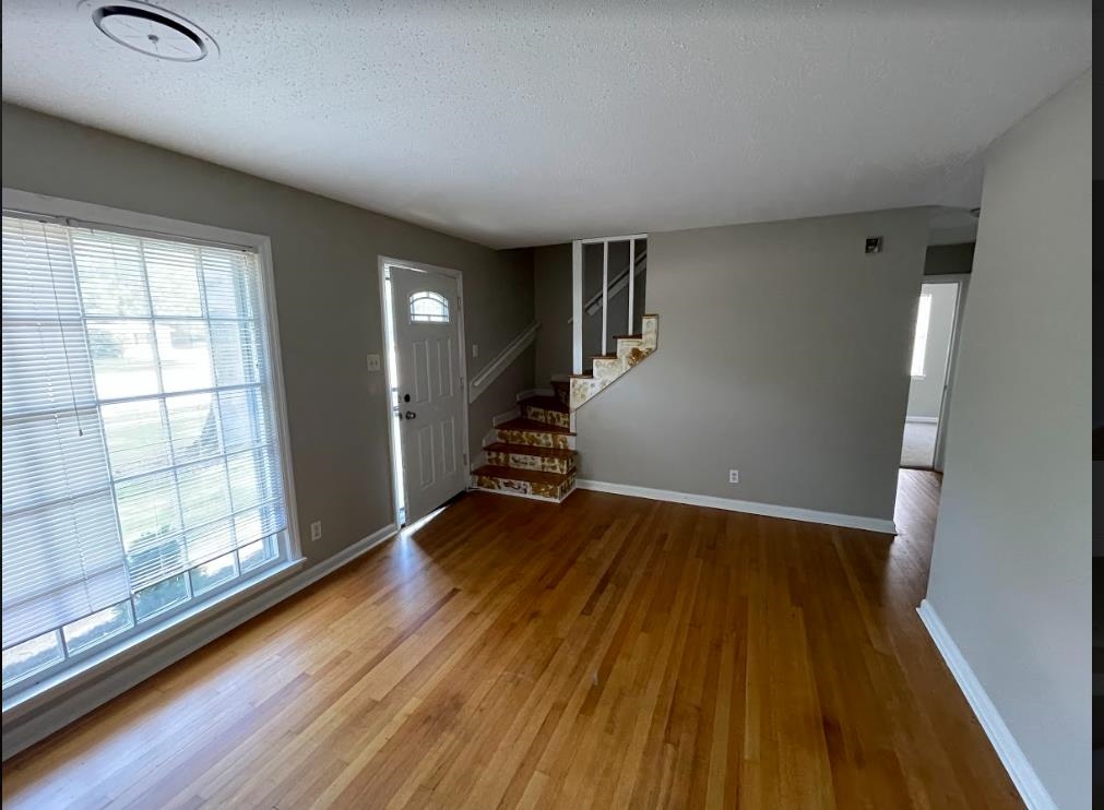 4875 Knight Arnold Road Memphis, TN 38118 - Photo 5 of 16 wooden floor in an empty room with a window
