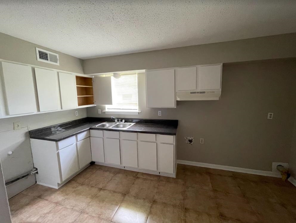 4875 Knight Arnold Road Memphis, TN 38118 - Photo 6 of 16 a kitchen with stainless steel appliances granite countertop a sink and a stove