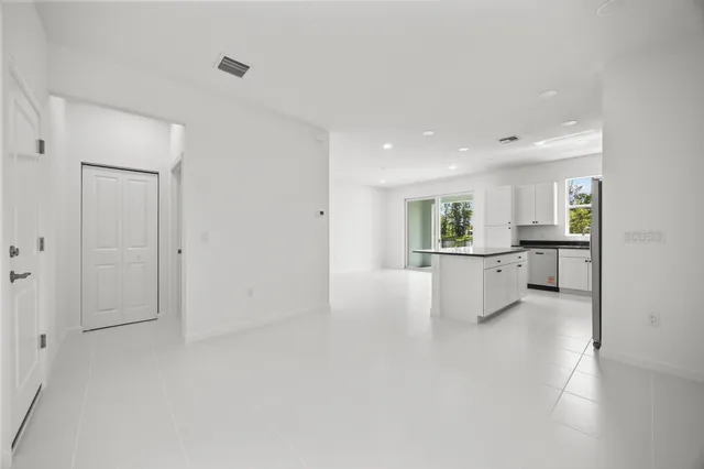 a kitchen with granite countertop a sink a stove and cabinets