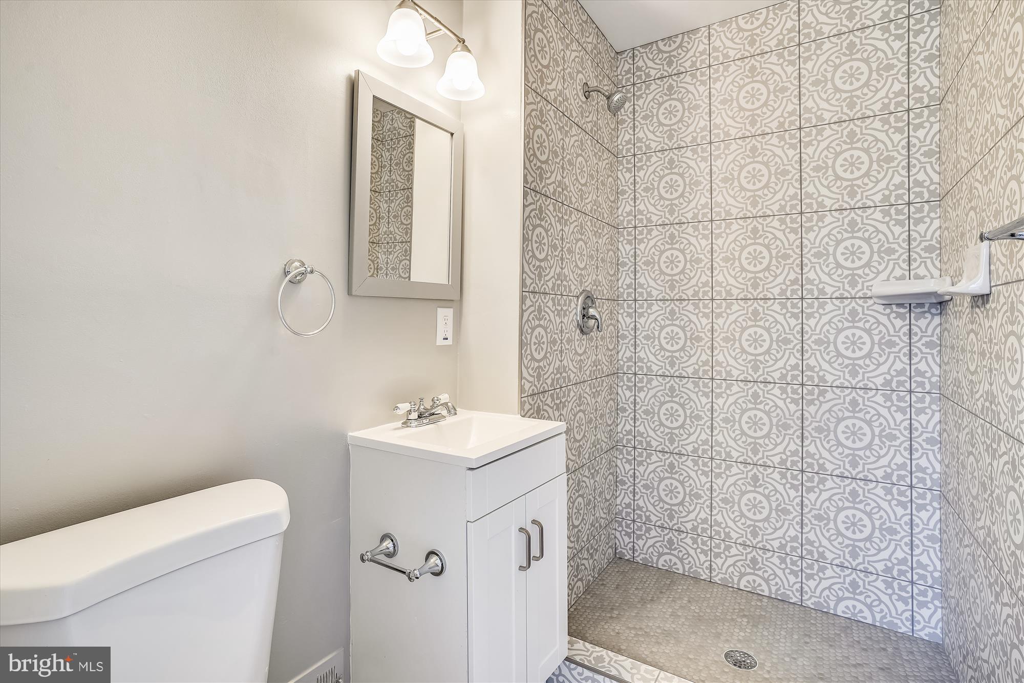 9202 Sprucewood Road Burke, VA 22015 - Photo 18 of 21 a bathroom with a sink a toilet and shower