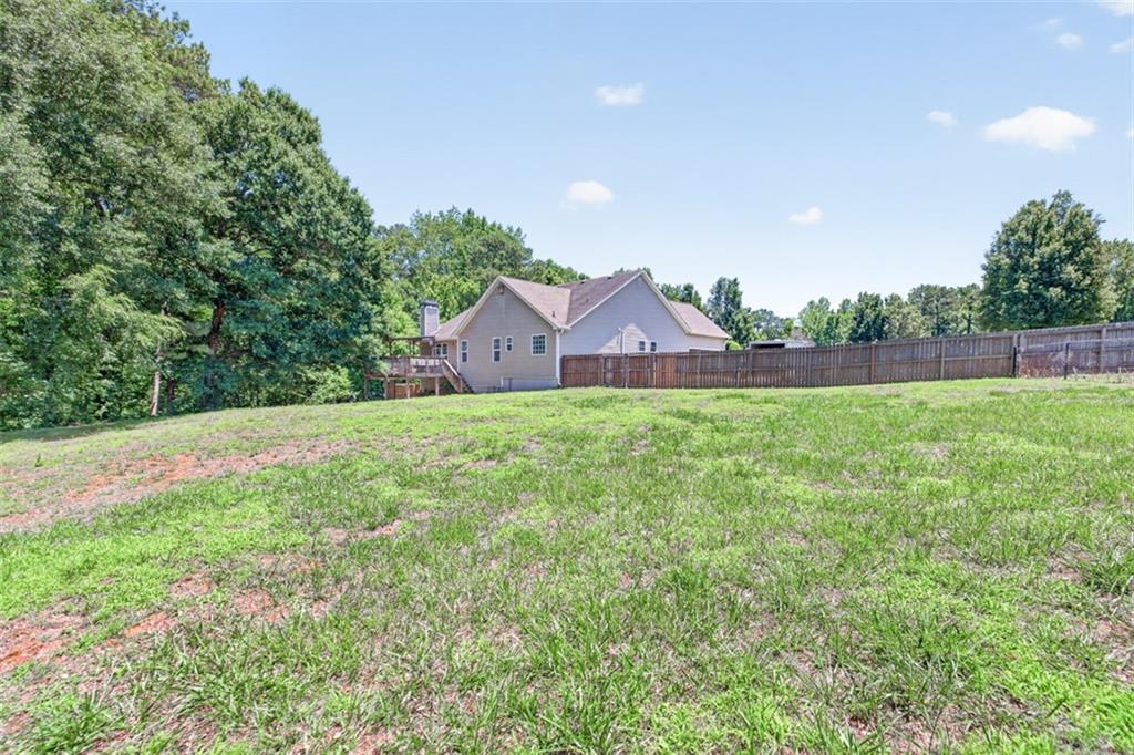 89 Katie Spring Lane Jefferson, GA 30549 - Photo 54 of 63 a view of a house with a yard and a forest