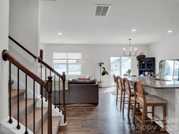 a dining room with furniture and wooden floor
