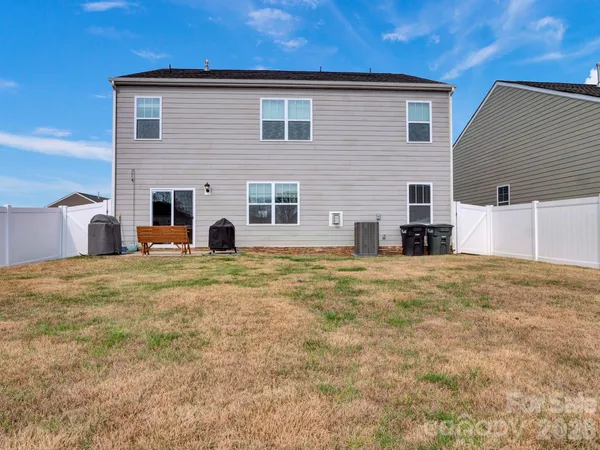a view of a house with a backyard and a table