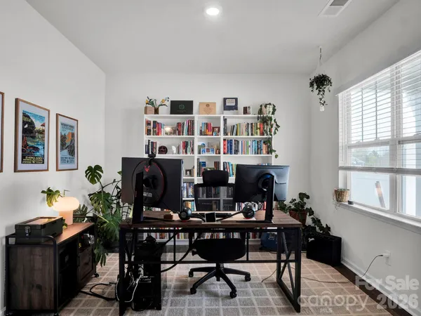 a view of a workspace with furniture and a potted plant