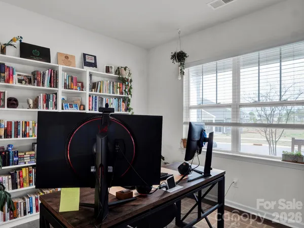 a room with a bookshelf and a window