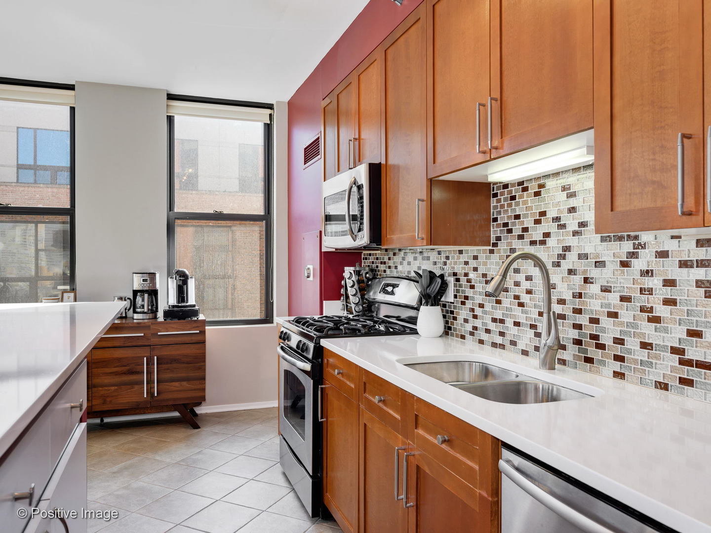 330 North Jefferson Street, Unit 904 Chicago, IL 60661 - Photo 17 of 27 a kitchen with stainless steel appliances a sink a stove and a refrigerator