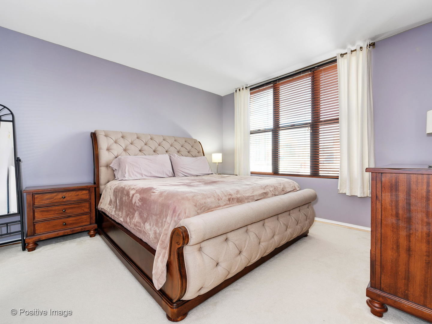 330 North Jefferson Street, Unit 904 Chicago, IL 60661 - Photo 19 of 27 a bed sitting in a spacious bedroom next to a window