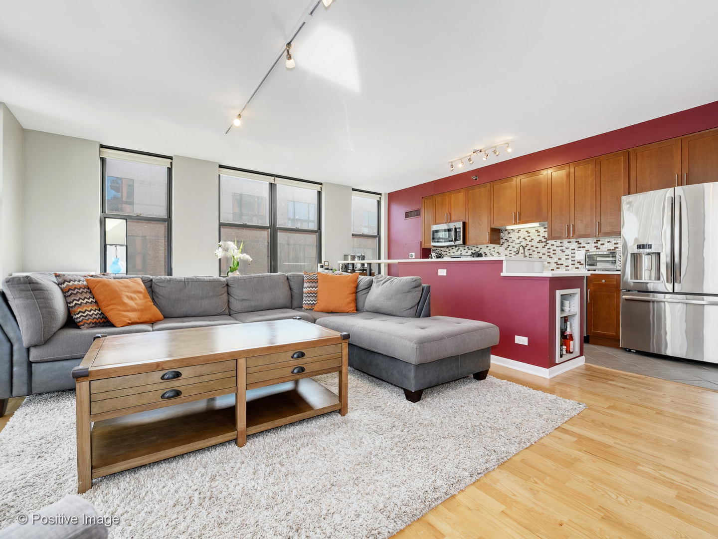 330 North Jefferson Street, Unit 904 Chicago, IL 60661 - Photo 5 of 27 a living room with furniture a kitchen island with furniture flat screen tv and refrigerator