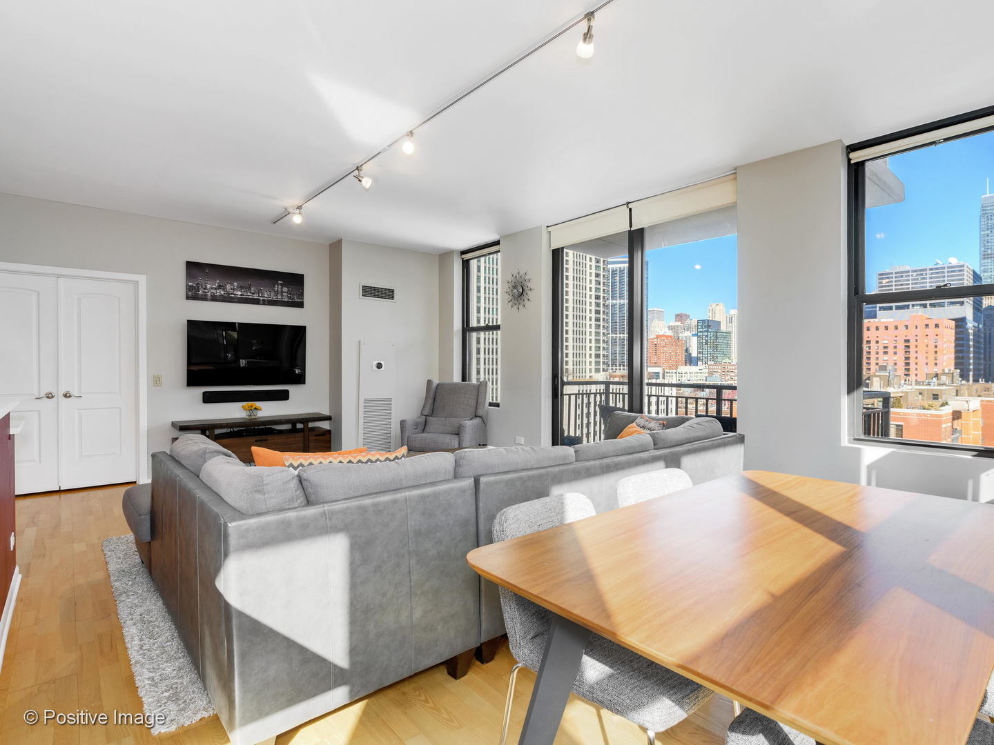 330 North Jefferson Street, Unit 904 Chicago, IL 60661 - Photo 9 of 27 a living room with furniture and a flat screen tv