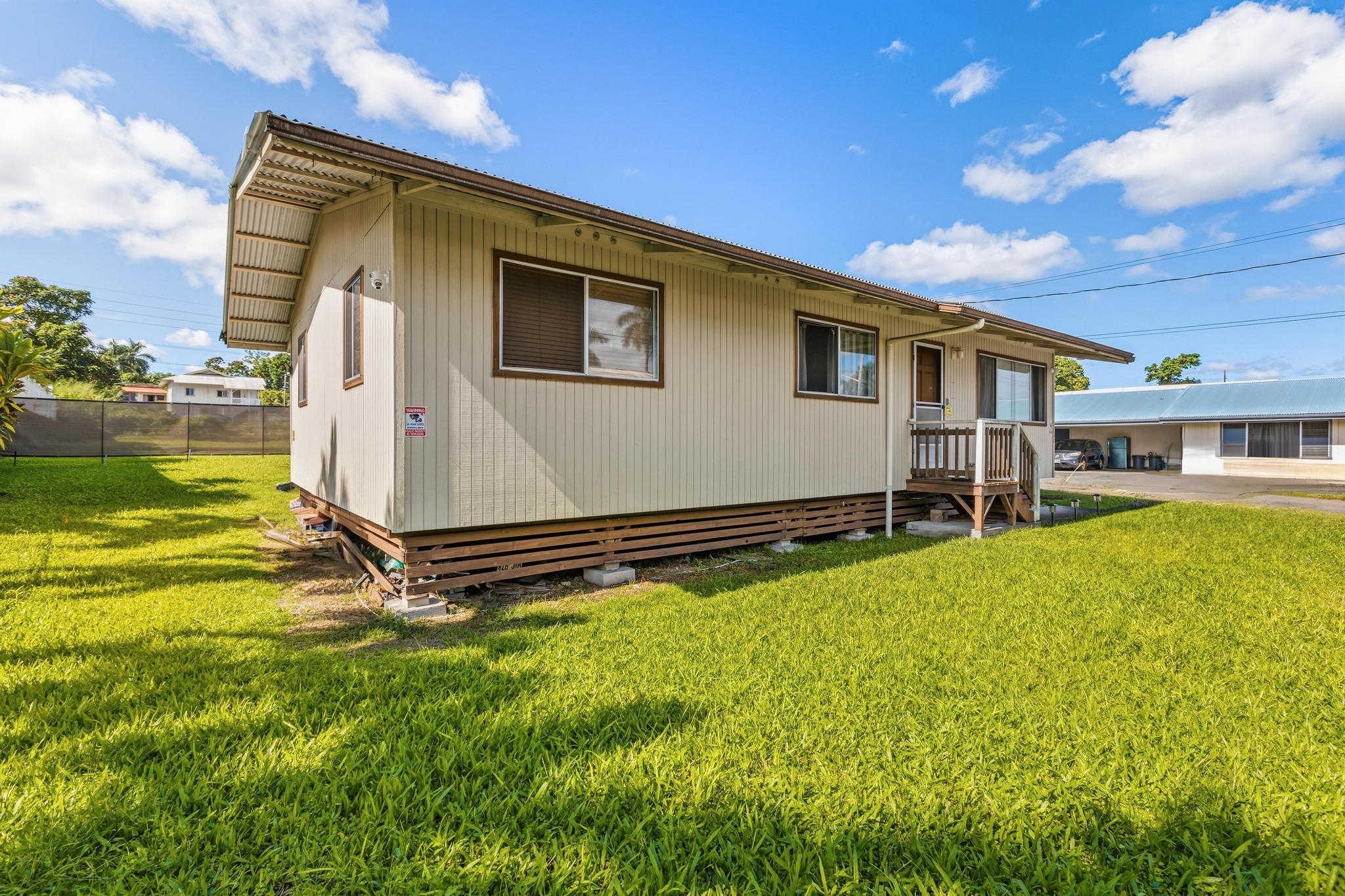 1560 Kilauea Avenue Hilo, HI 96720 - Photo 12 of 29 a front view of a house with a yard