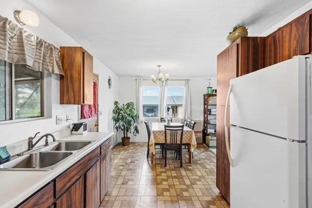 a bathroom with a granite countertop sink a toilet and a mirror