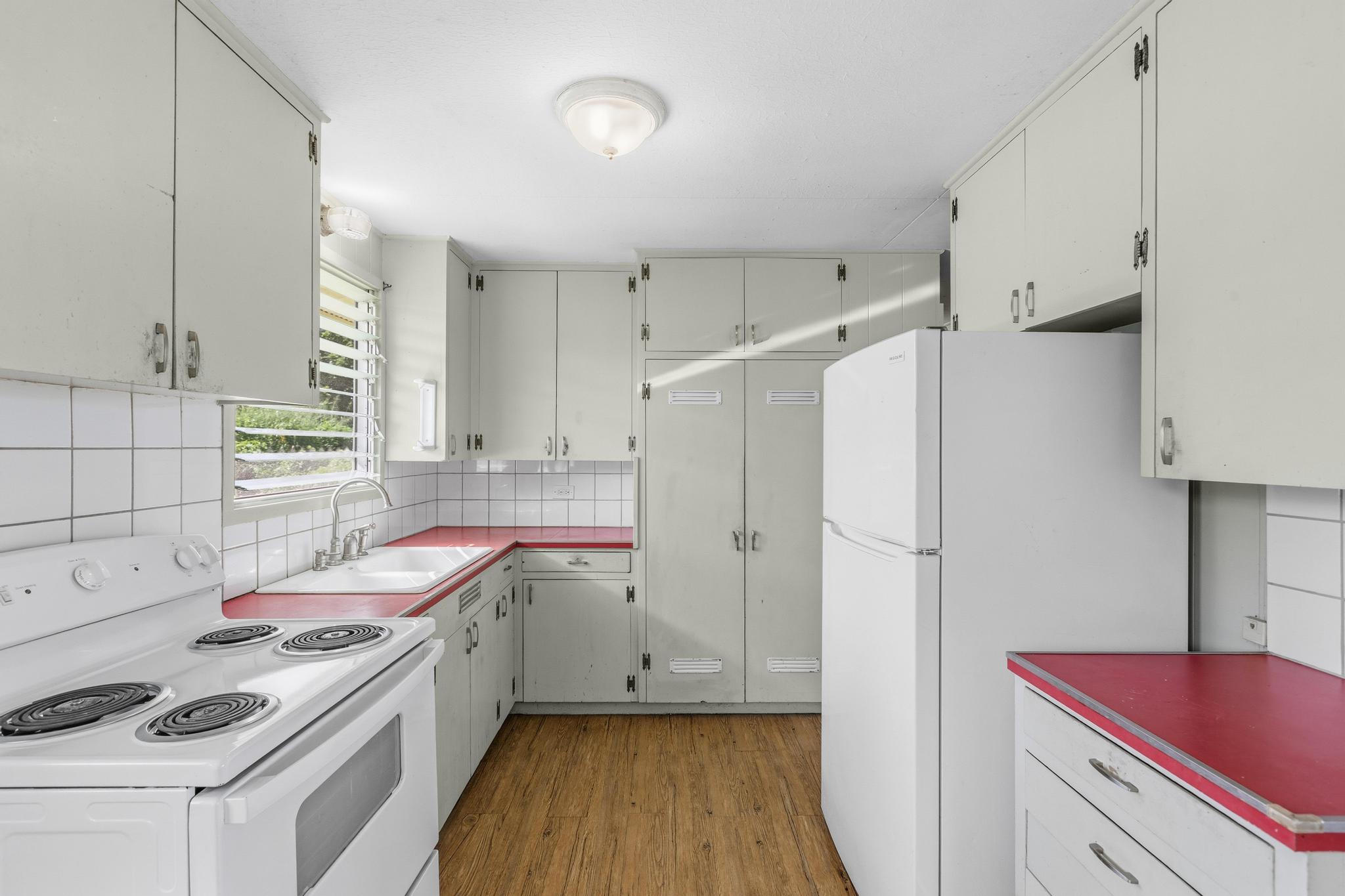 1560 Kilauea Avenue Hilo, HI 96720 - Photo 19 of 29 a kitchen with a sink stove and refrigerator