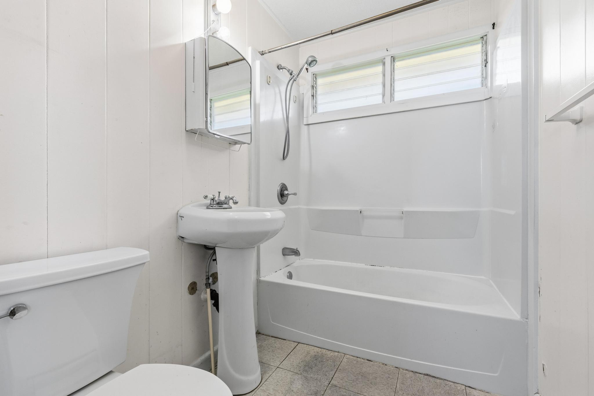 1560 Kilauea Avenue Hilo, HI 96720 - Photo 24 of 29 a bathroom with a sink a toilet and shower